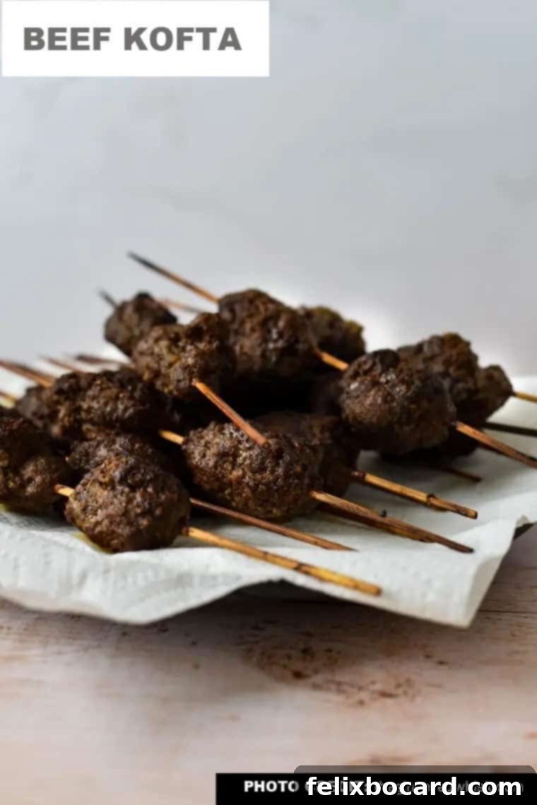 Easy and flavorful beef kofta skewers served with flatbread, hummus, cucumbers, and tomatoes.