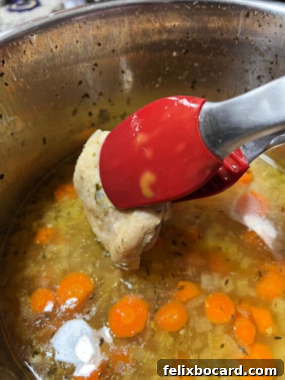Removing cooked chicken from Instant Pot.