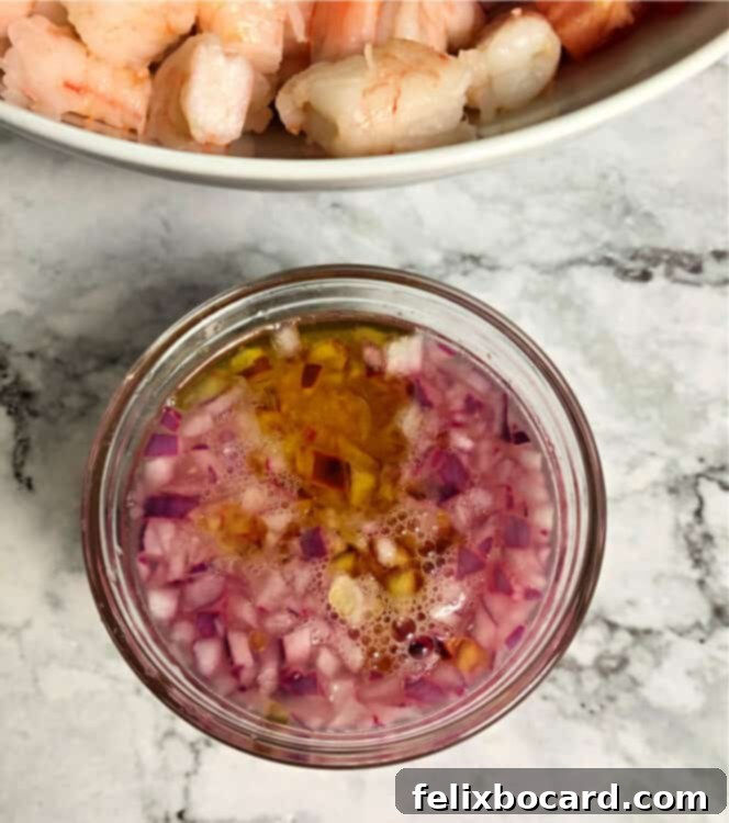 chopped red onion in a small cup with a marinade