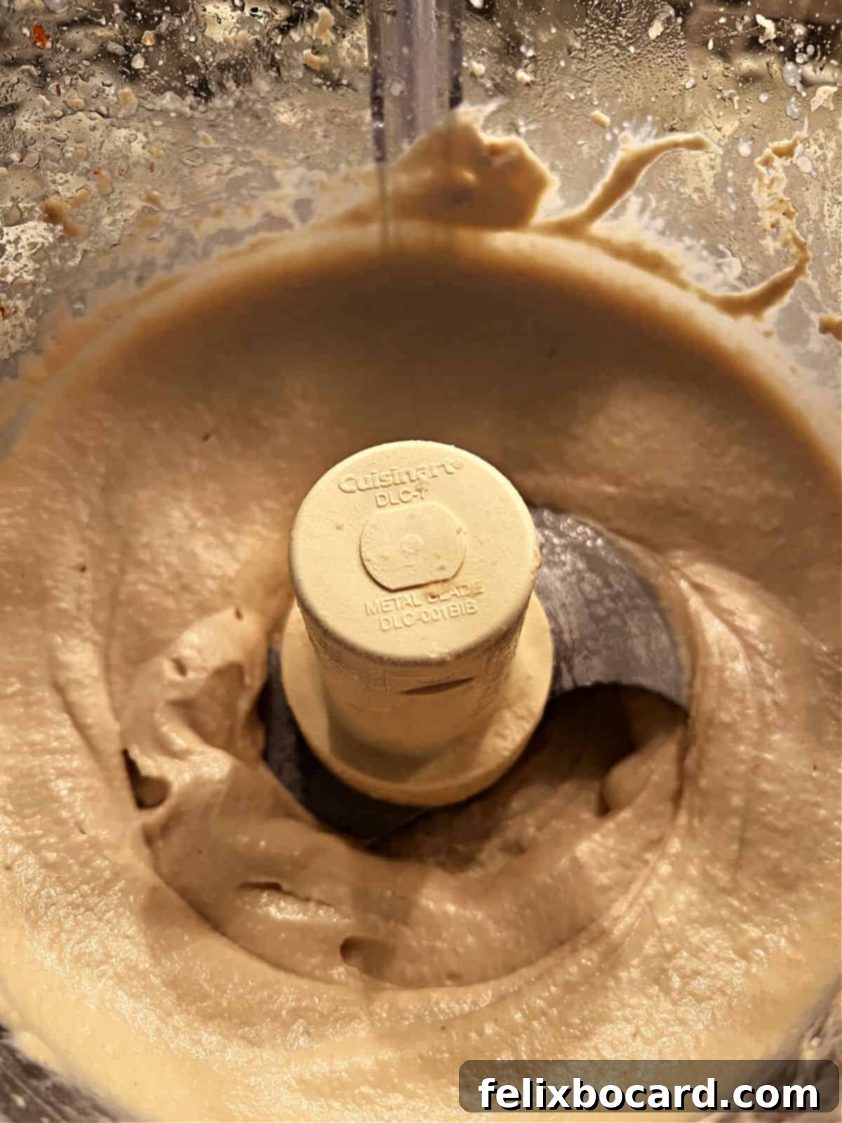 Butter bean hummus in a food processor, perfectly blended and smooth.