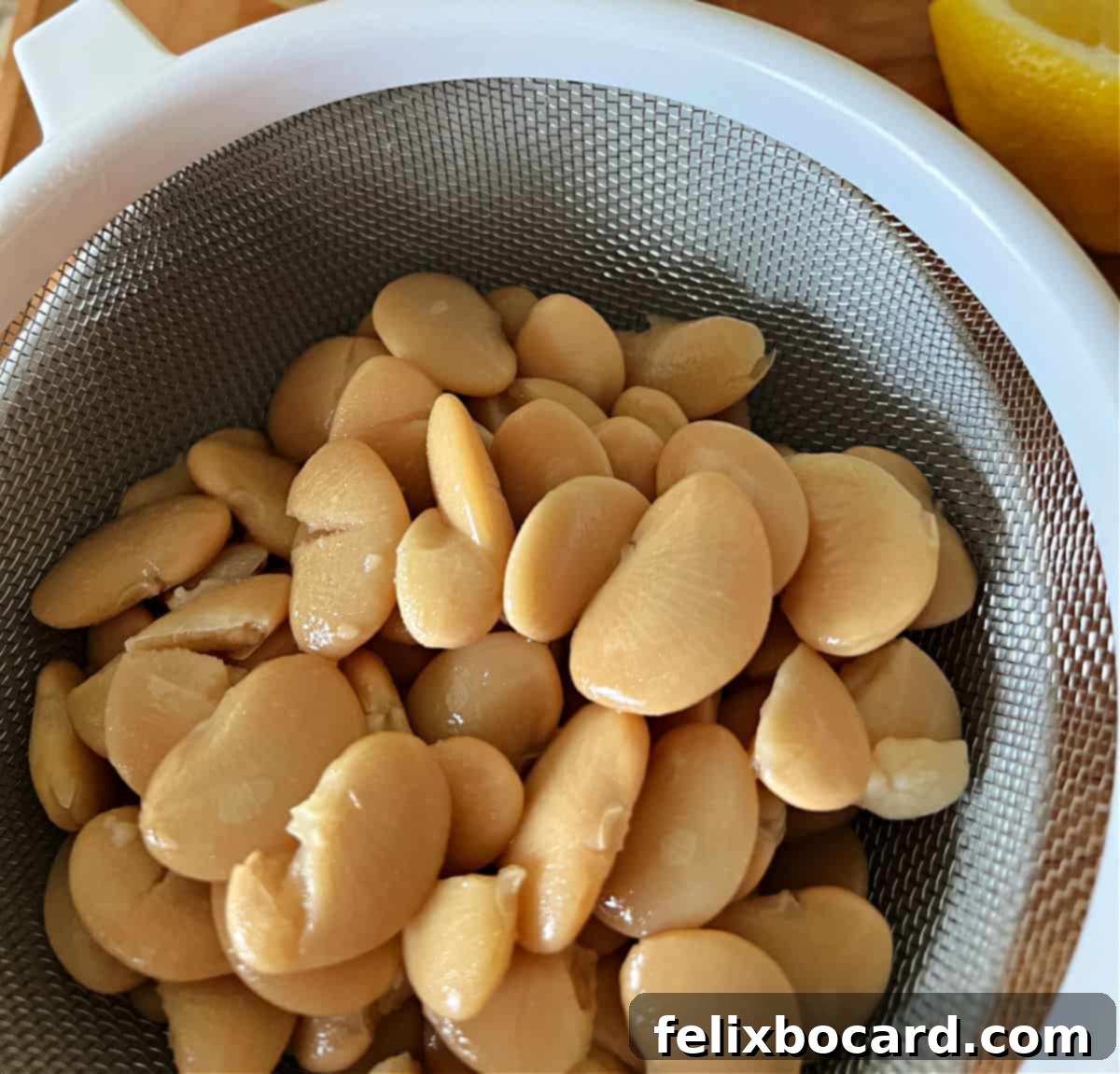 Close-up of butter beans being drained from a can.