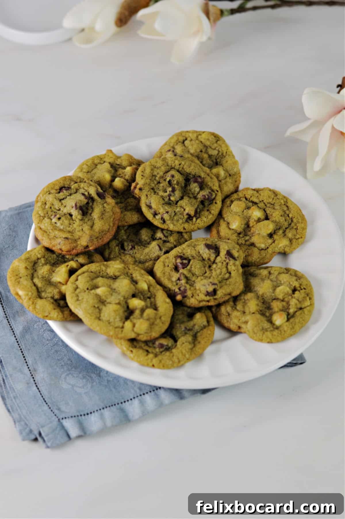 Matcha chocolate chip cookies served on a white plate.