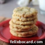 A stack of golden brown oatmeal coconut cookies on a small red plate.