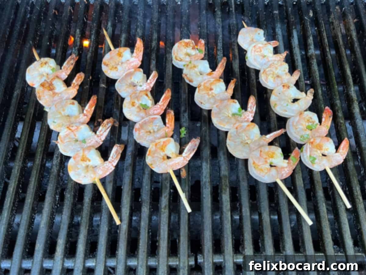 Fiesta Lime Grilled Shrimp Skewers 7 Shrimp skewers cooking on a grill.