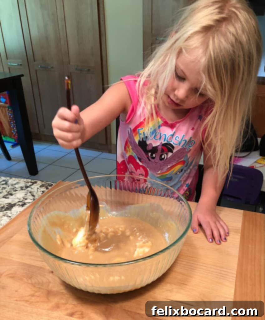 A person preparing bird suet with a child assistant