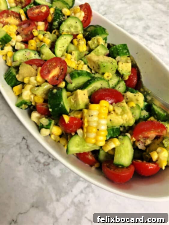 close up of corn tomato avocado salad, highlighting its fresh ingredients.