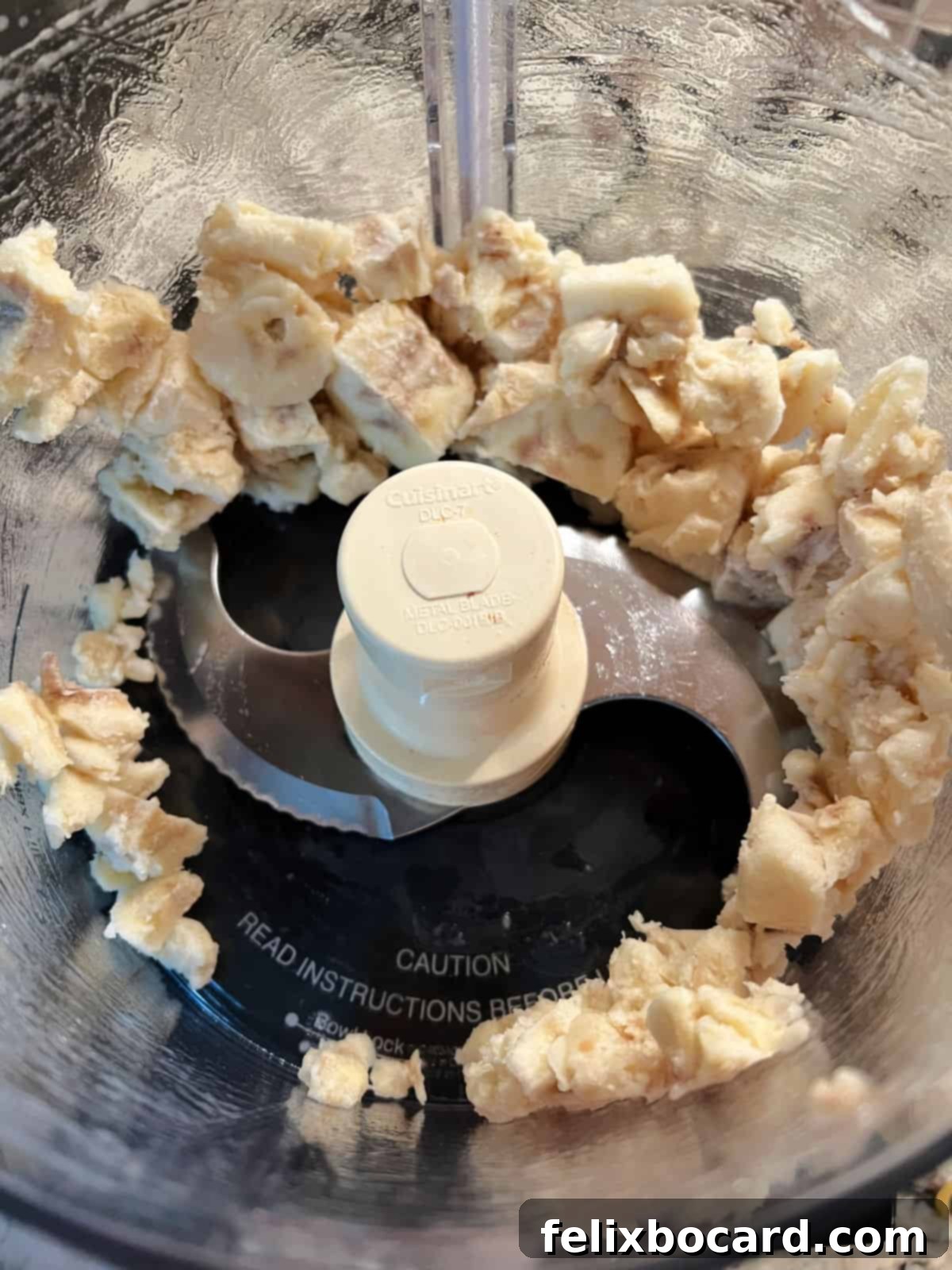 frozen bananas slightly broken up in a food processor.
