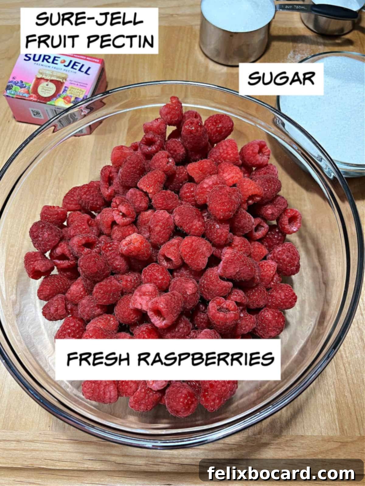 Homemade Reduced Sugar Raspberry Freezer Jam 3 ingredients: sure-jell, sugar, and raspberries.