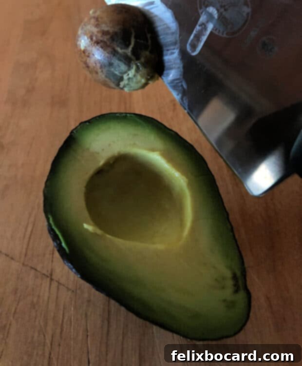 Removing the avocado pit with a simple twist after embedding the knife