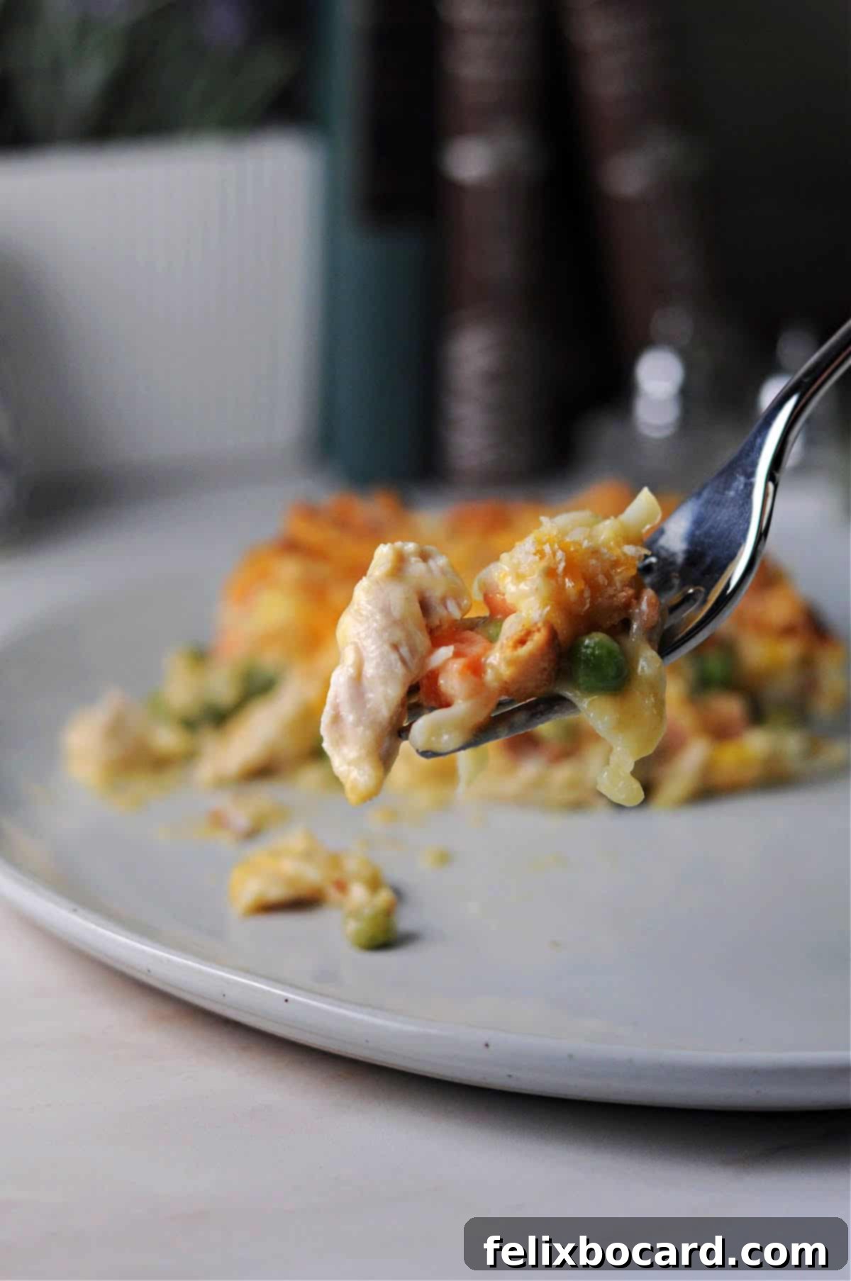 Forkful of creamy chicken hash brown casserole