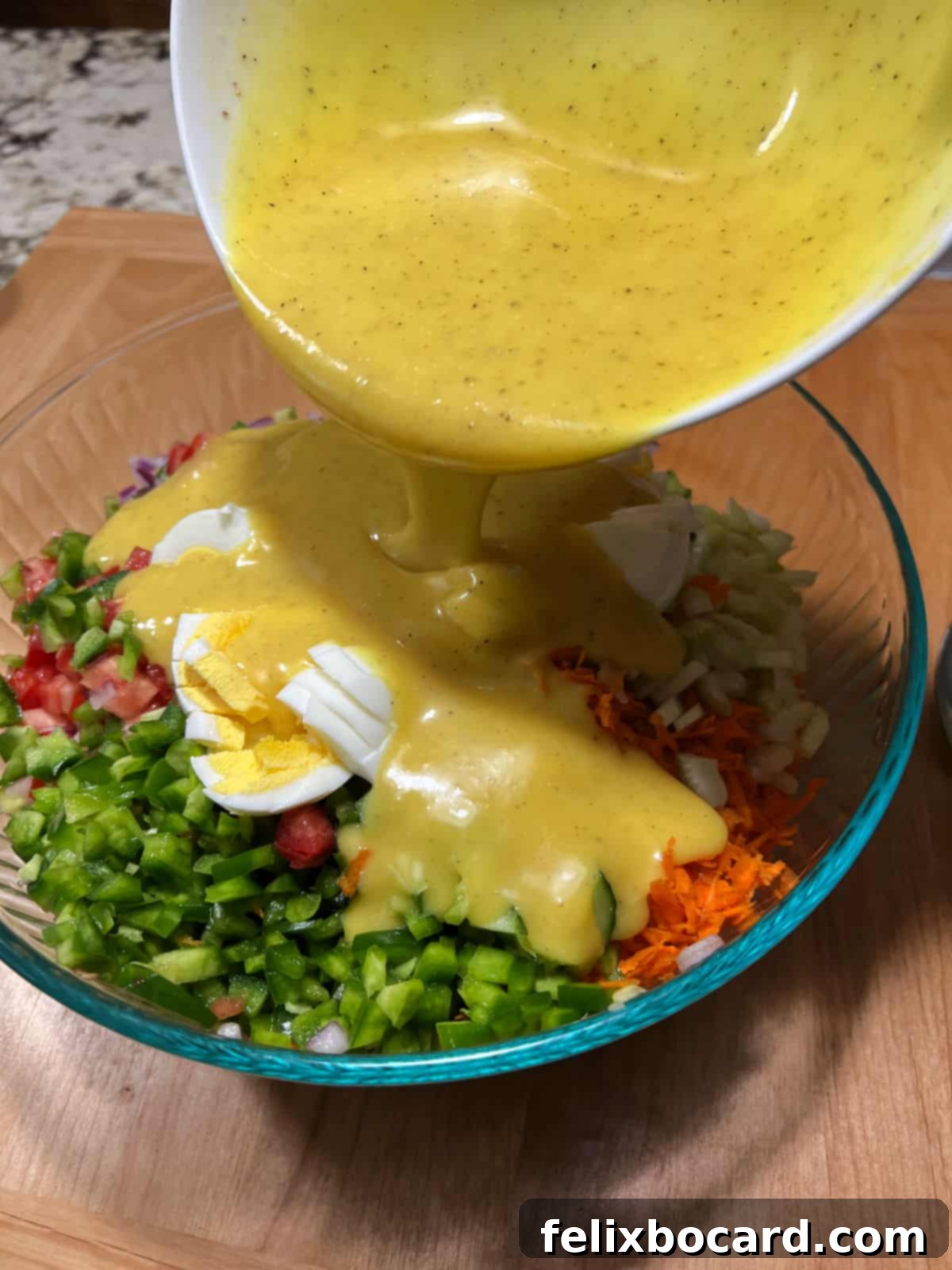 Irresistibly Sweet Macaroni Salad 6 pouring dressing over the salad.