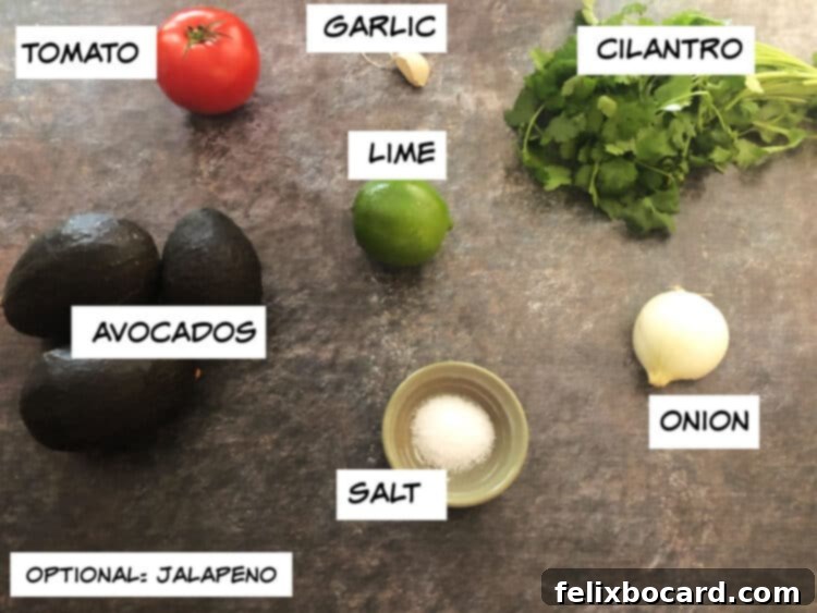 Ultimate Avocado Fiesta 3 A beautiful spread of fresh guacamole ingredients: ripe avocados, a red tomato, a bright green lime, garlic cloves, fresh cilantro, and a white onion, all ready for preparation.