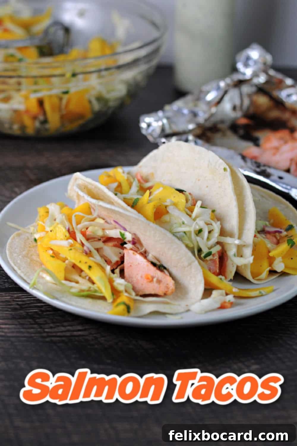 BBQ Salmon Tacos with Tangy Slaw 6 A Pinterest pin image featuring BBQ Salmon Tacos with Mango Slaw, highlighting the fresh ingredients and grilled salmon.