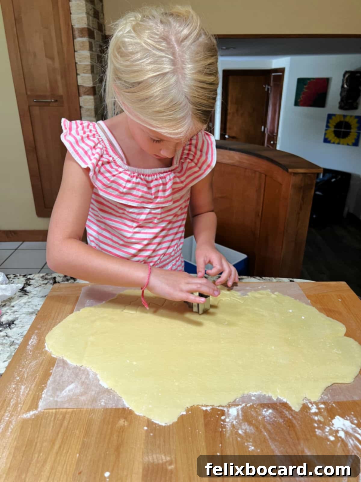 Using a bat cookie cutter to create shapes from dough.