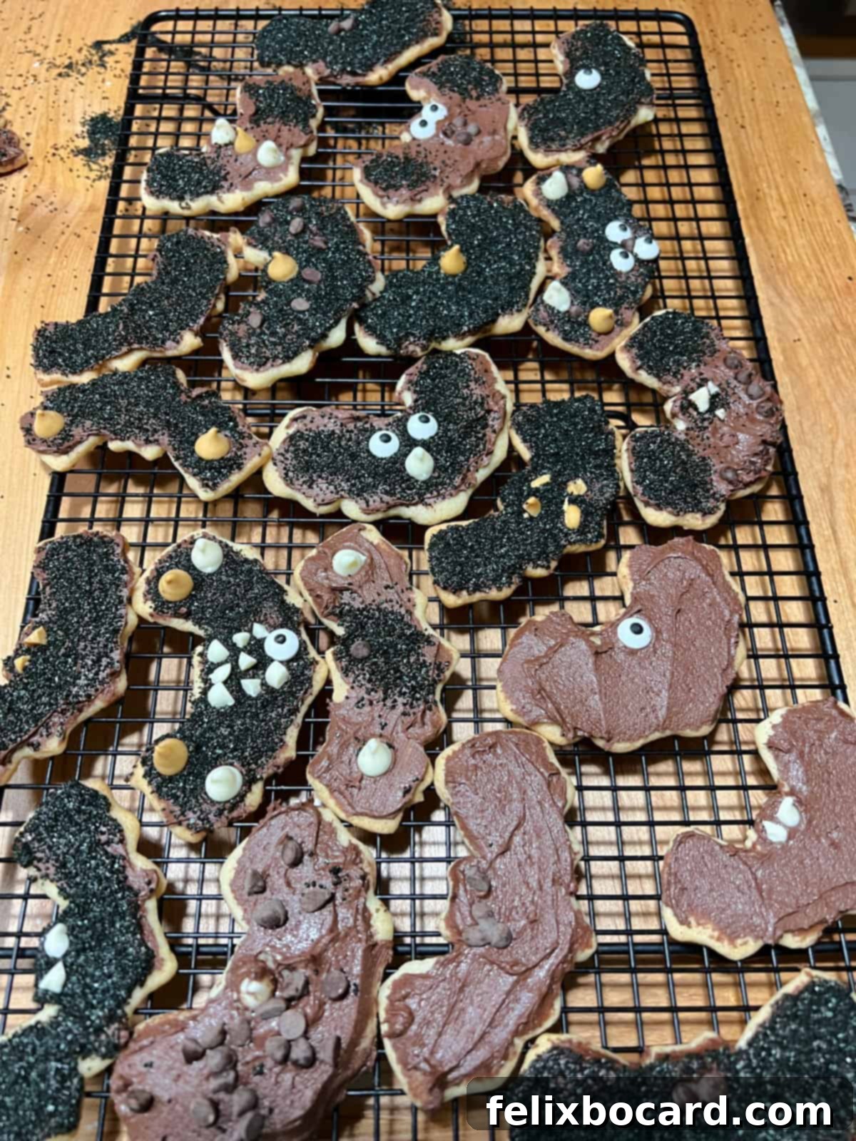 Cooling rack filled with various bat-decorated sugar cookies.