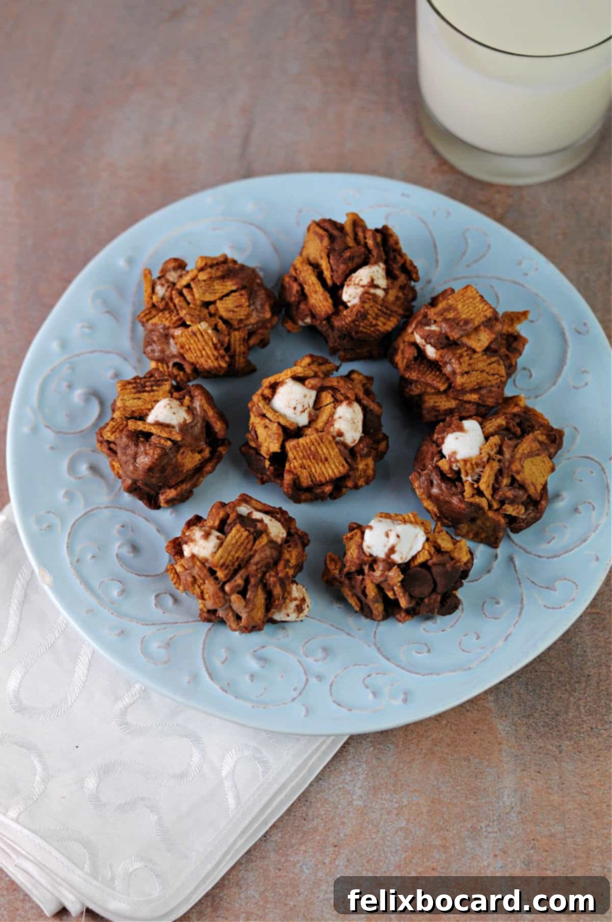 Top down view of delicious no-bake s'mores cookies arranged neatly on a vibrant blue plate.