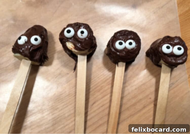 close up of 4 banana pops decorated with googly eyes