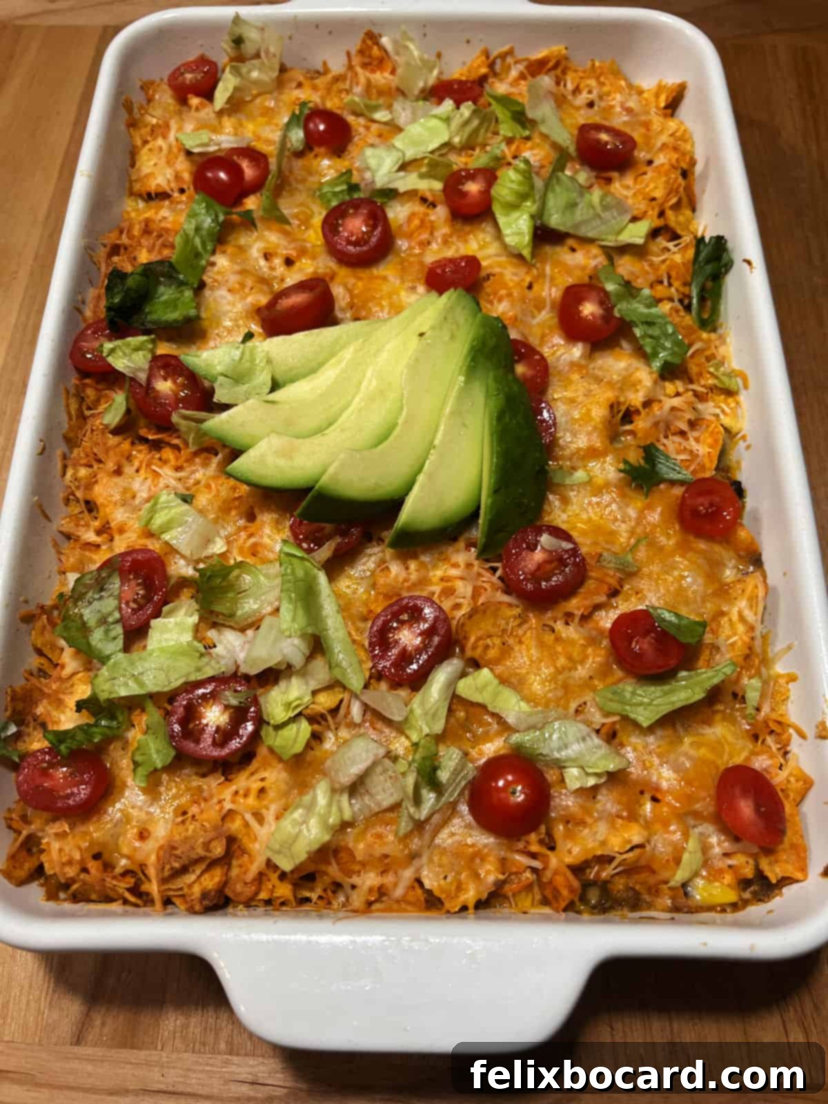 Cheesy Dorito Ground Beef Bake 2 A pan of Dorito casserole with ground beef, fresh out of the oven, showing melted cheese and crispy Doritos.