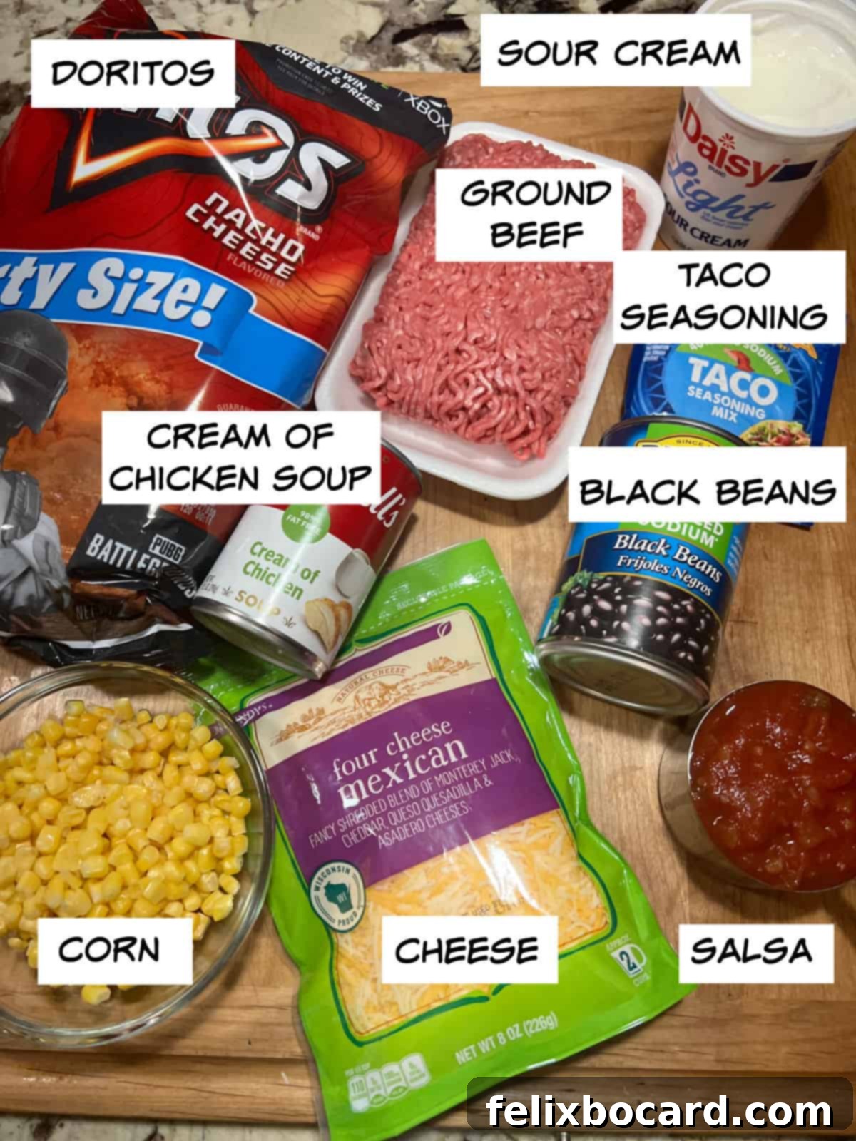 Cheesy Dorito Ground Beef Bake 3 A collection of ingredients for Dorito casserole: Doritos, ground beef, taco seasoning, black beans, cream of chicken soup, corn, salsa, and shredded cheese.