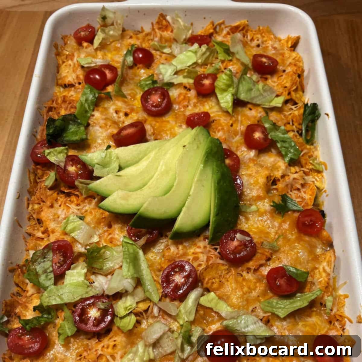 Cheesy Dorito Ground Beef Bake 8 A full pan of Dorito Casserole with ground beef, garnished with fresh cilantro, ready to be served.