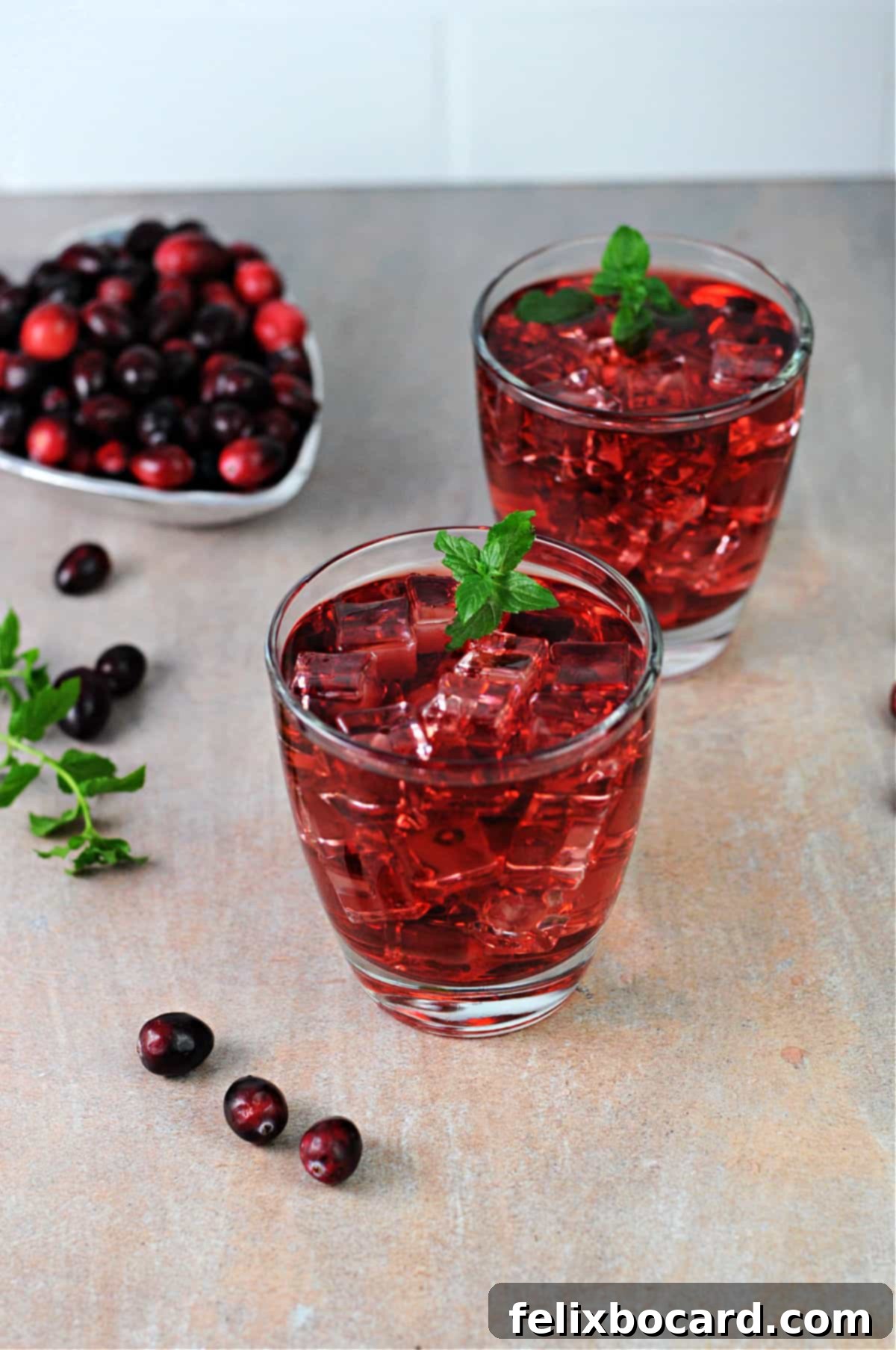 Two glasses of vibrant cranberry juice, viewed from above, suggesting refreshment and health.