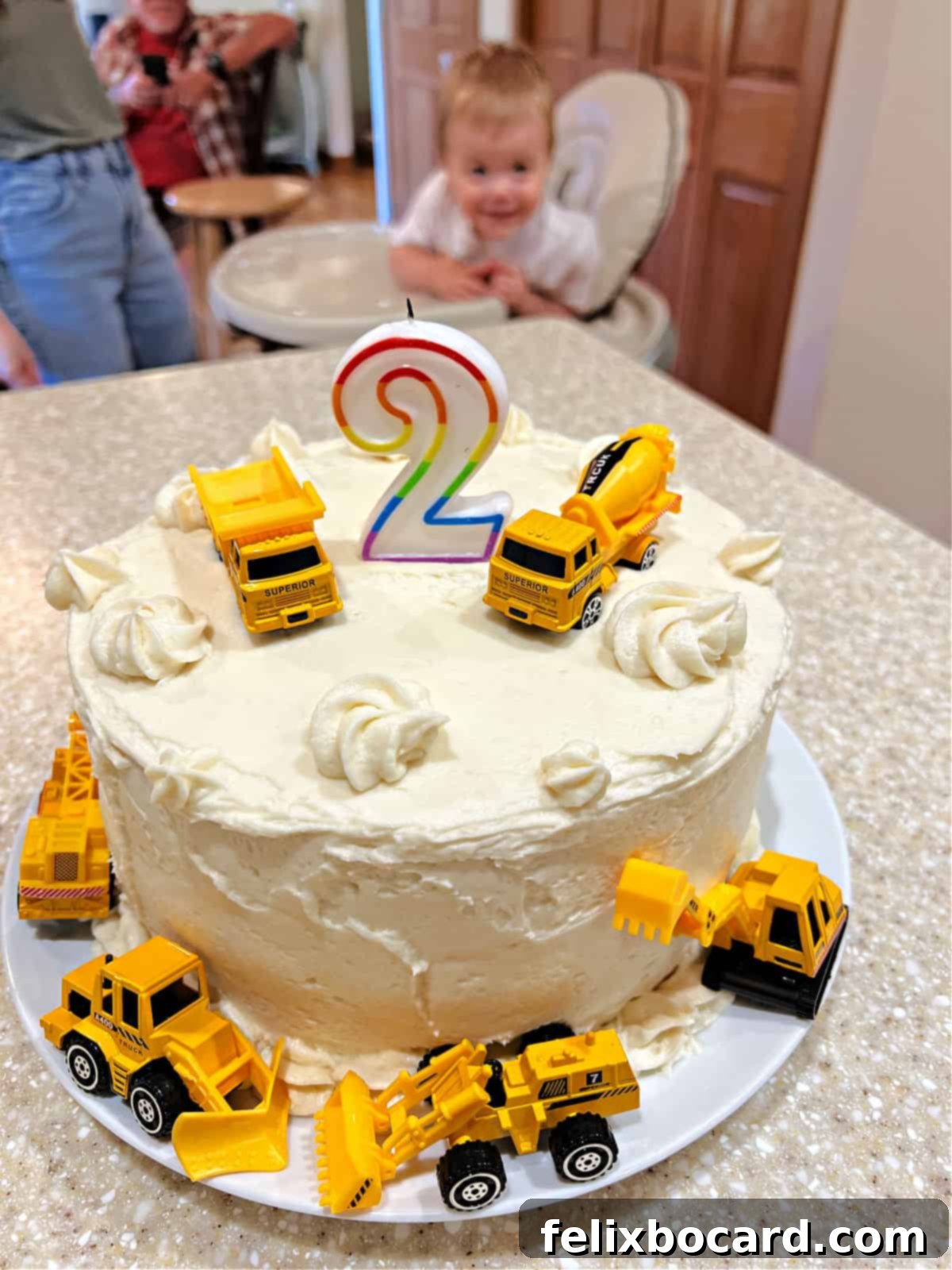 Delightful cake decorated for a 2-year-old's birthday celebration, featuring a vibrant strawberry filling.