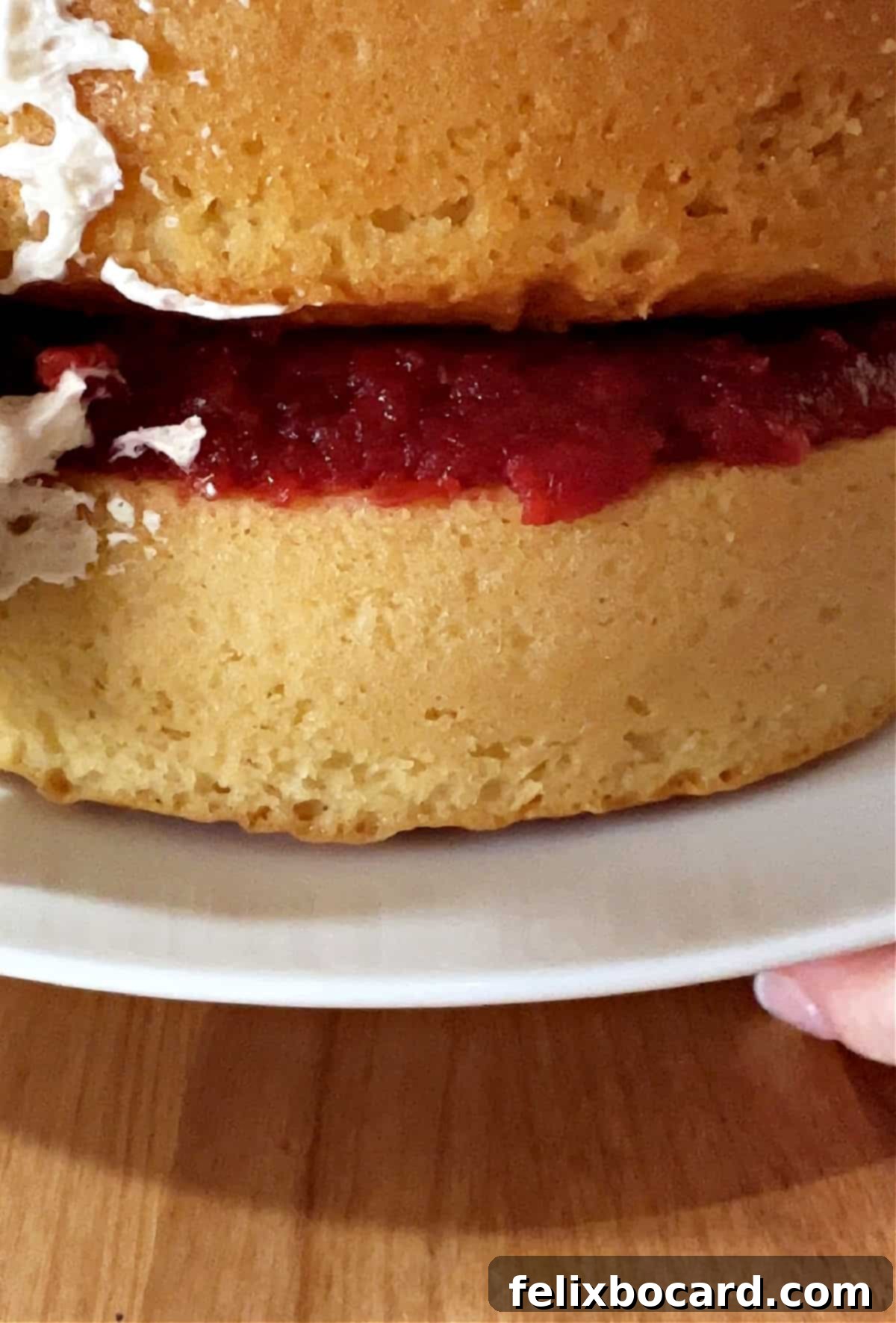 Two soft vanilla cake layers separated by a luscious layer of homemade strawberry filling.