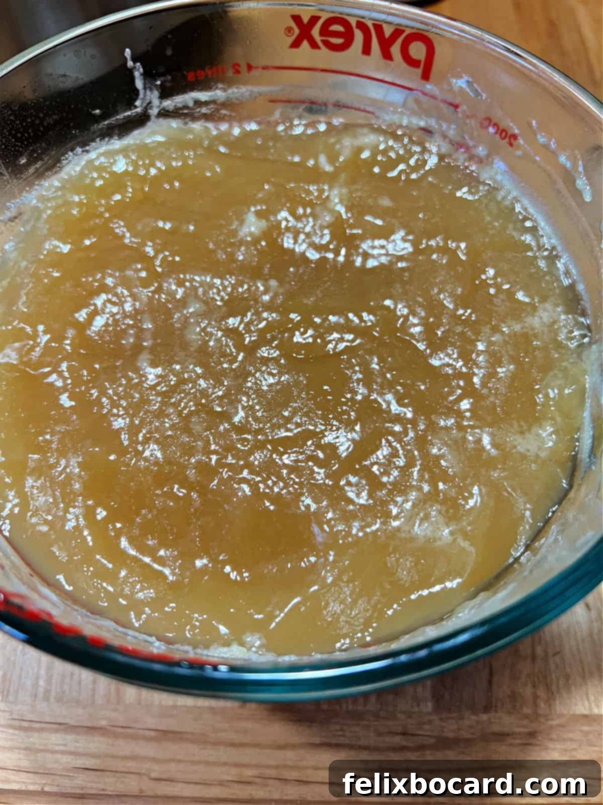 A close-up of cold bone broth showing a thick, gelatinous texture, a sign of high collagen content.