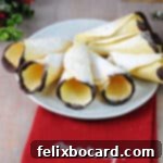 Norwegian Christmas Krumkake 12 Plate of krumkaker dipped in chocolate and dusted with powdered sugar.