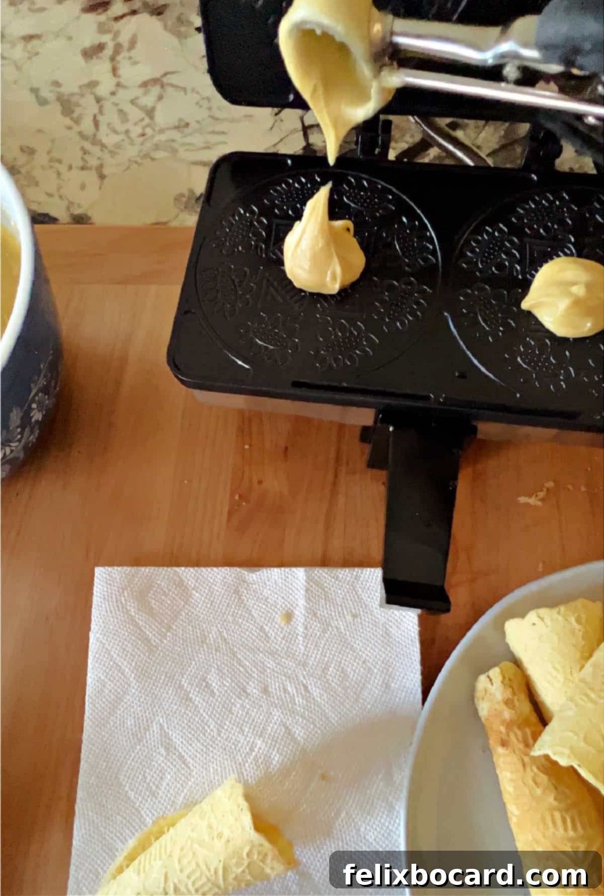 Norwegian Christmas Krumkake 6 Scoop of Krumkake batter being placed into the preheated Krumkake baker.