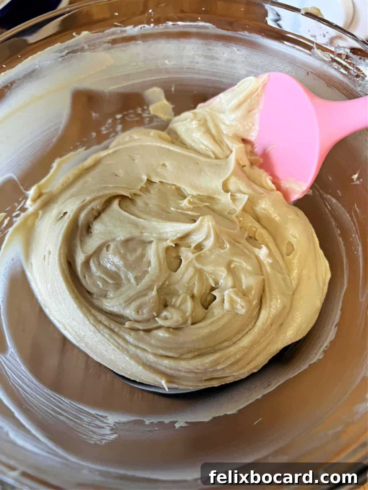 Creamy brown sugar and cream cheese dip in a mixing bowl, perfectly blended and smooth.