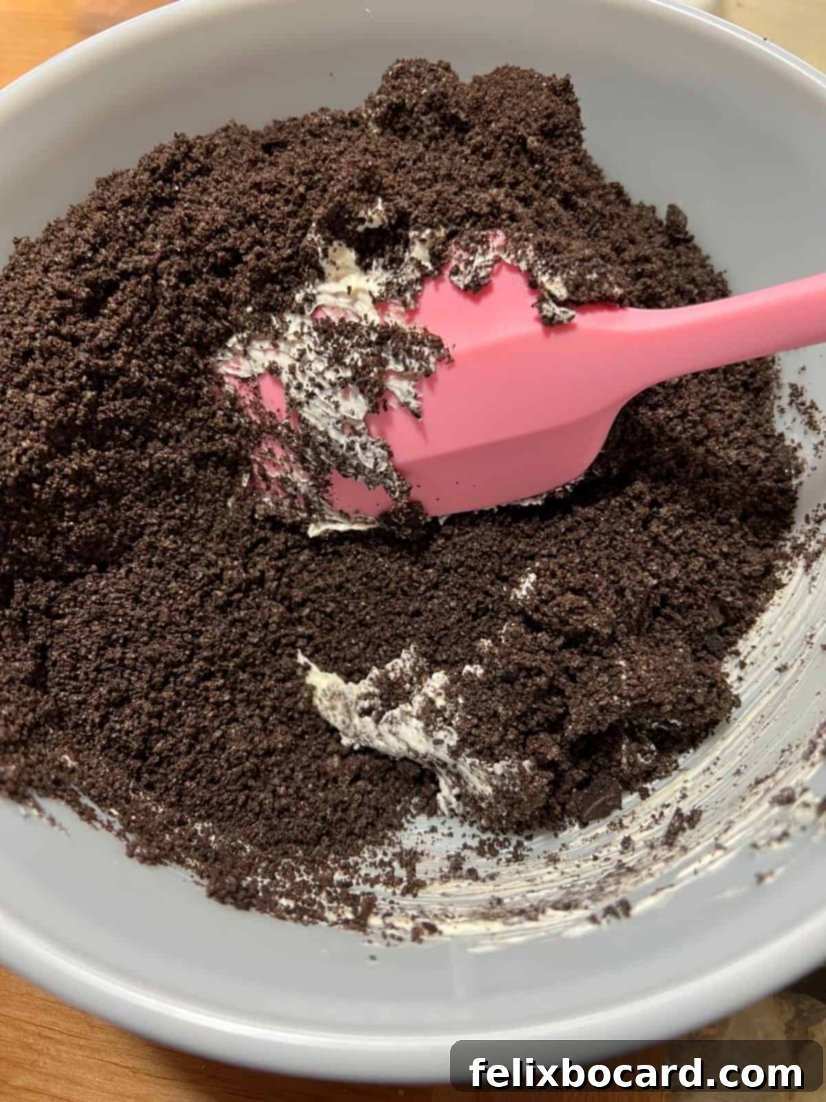 Snowman Oreo Truffles 4 crumbs mixing with cream cheese in a bowl.