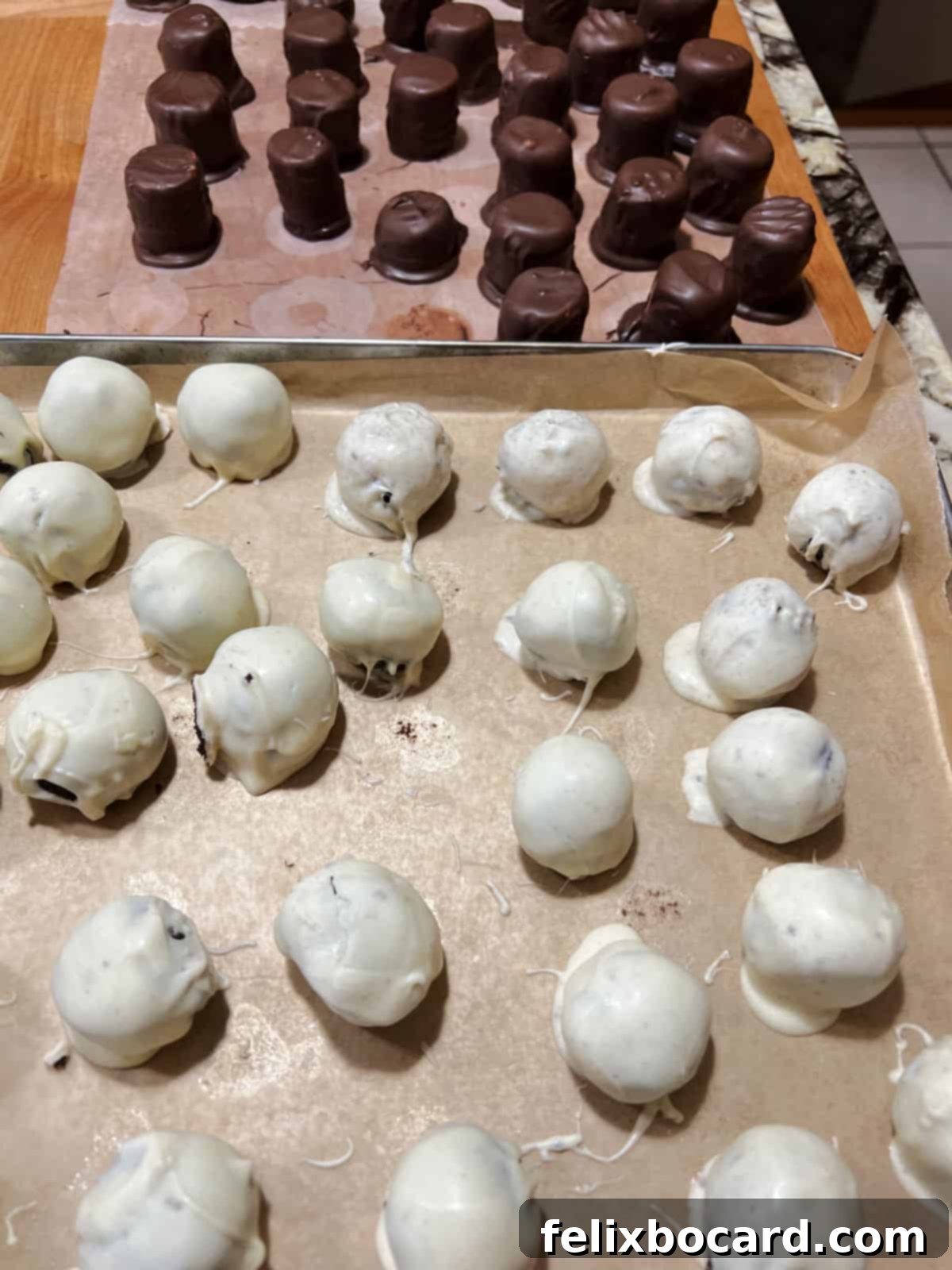 Snowman Oreo Truffles 7 white coated oreo balls with dipped hats behind them.