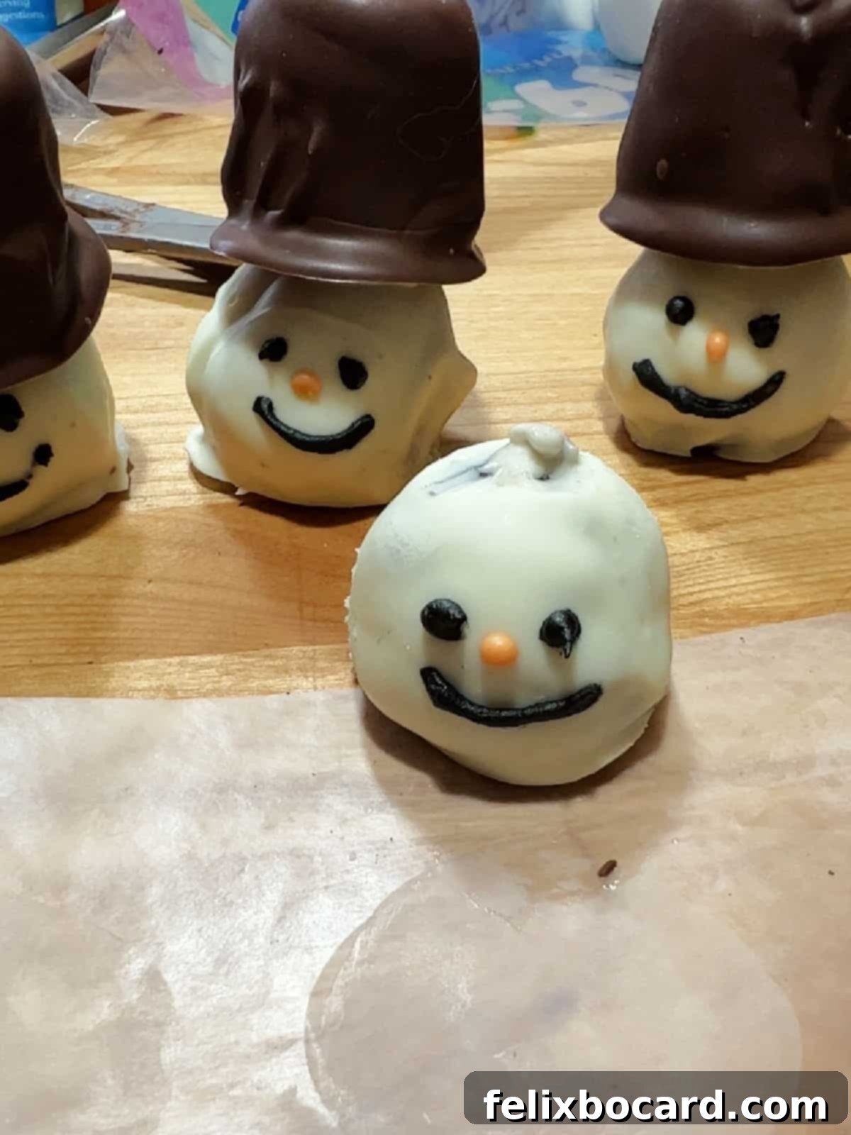 Snowman Oreo Truffles 8 snowman face oreo ball with a dab of melted white chocolate on top.