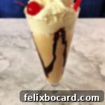 Kahlua Mudslide 3 Kahlua Mudslide ice cream drink in a tall glass topped with whipped cream and a cherry