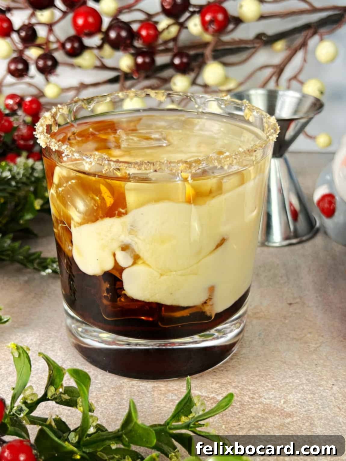 Yuletide White Russian 2 A festive Eggnog White Russian cocktail ready to be stirred, garnished with a sprinkle of nutmeg.