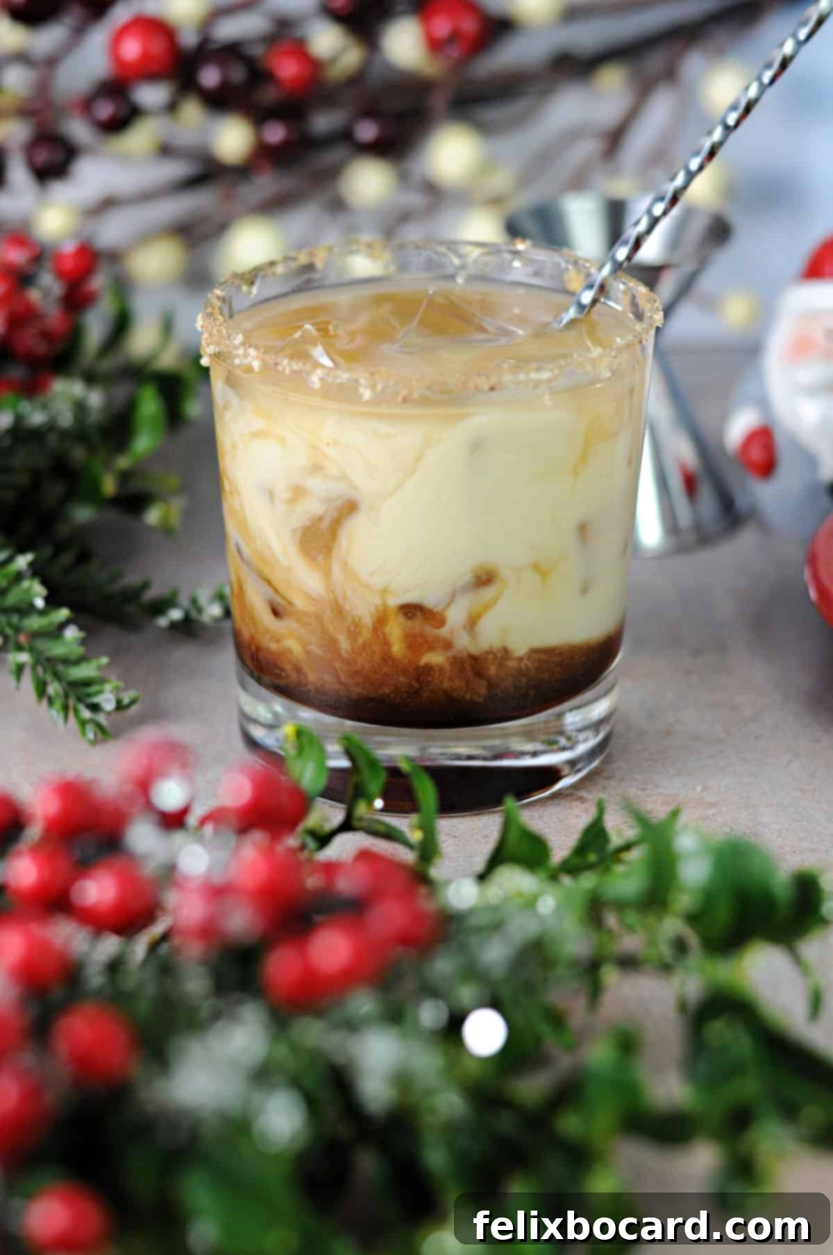 Yuletide White Russian 4 A hand stirring an Eggnog White Russian cocktail in a glass filled with ice, ready for enjoyment.