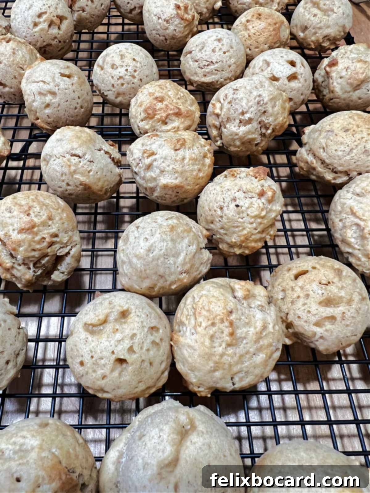 air fryer donut holes cooling on a rack before glazing.