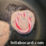 Minty Morning Flapjacks 11 Peppermint pancakes cooking in a pan, with faint smiley faces visible.