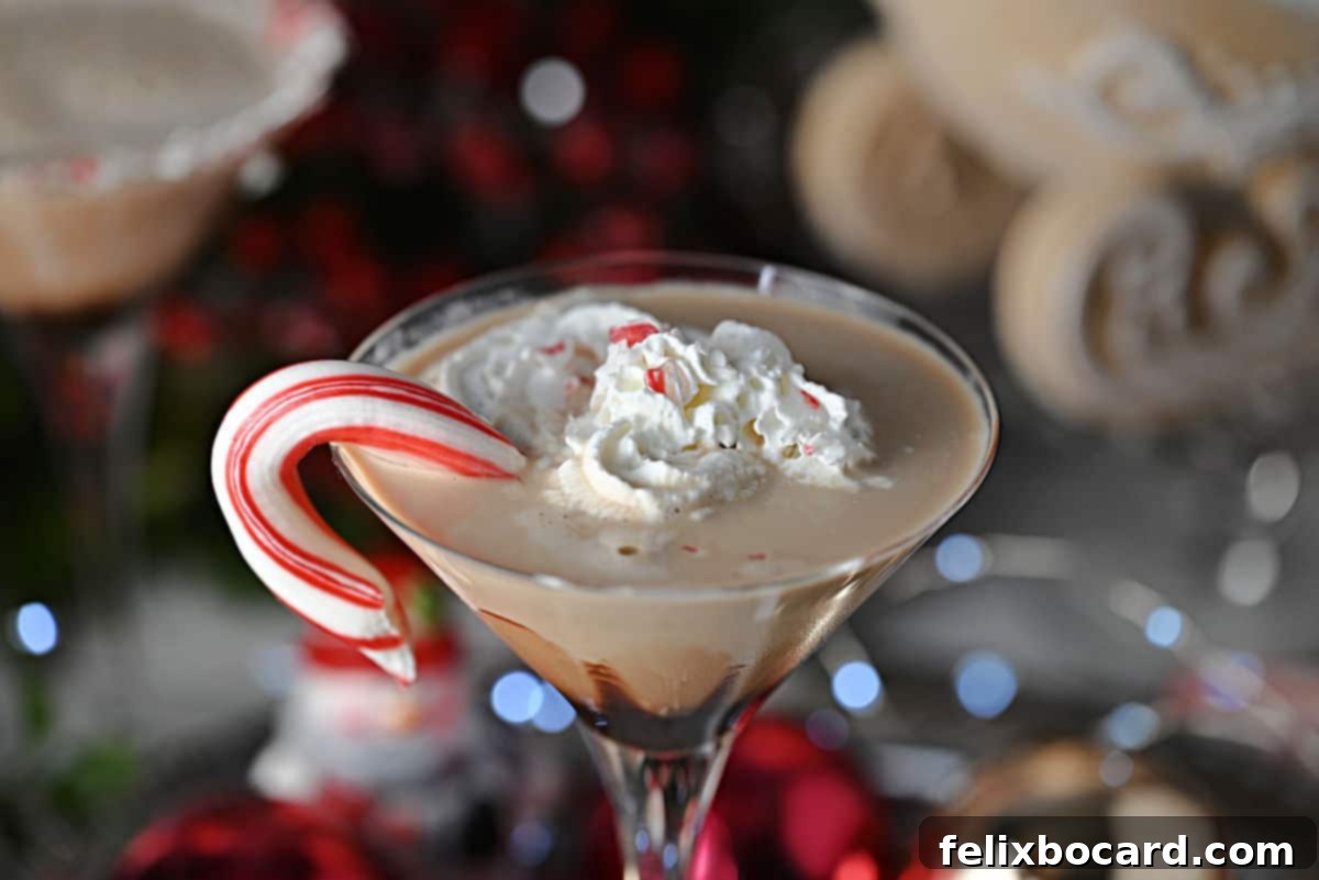 Close-up of a chocolate peppermint martini with a luxurious garnish of whipped cream and crushed candy canes.