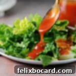 Whip Up Zesty Homemade Catalina Dressing 8 spoon of sweet catalina dressing pouring onto a green salad.