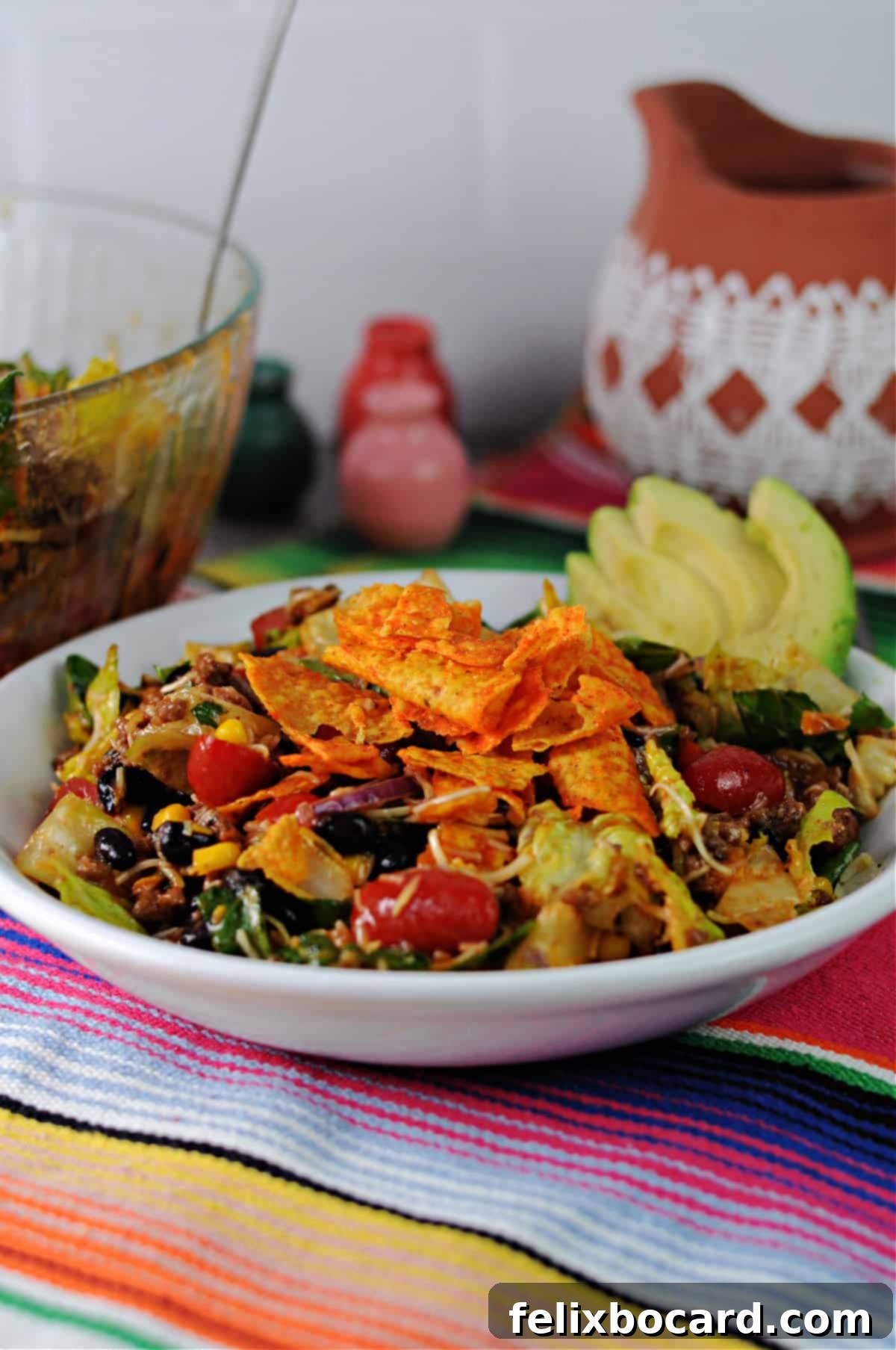 Individual serving of Dorito taco salad with crunchy Nacho Cheese Doritos crumbled on top, ready to eat.