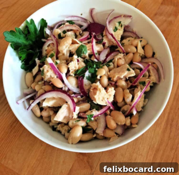 Fresh Tuna Bean Medley 2 Serving bowl of tuna and bean salad, garnished with fresh herbs.