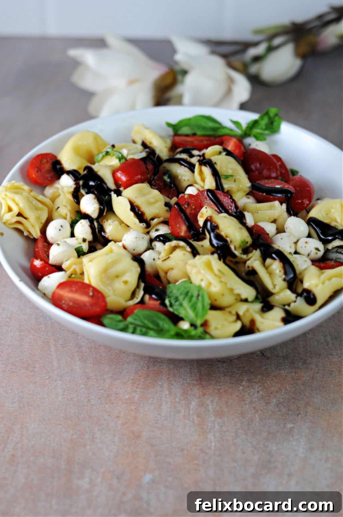 Vibrant Caprese Tortellini Salad 2 A vibrant bowl of Caprese tortellini salad, perfectly arranged and ready to serve, showcasing fresh ingredients.