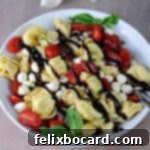 Vibrant Caprese Tortellini Salad 8 Serving bowl of Caprese tortellini salad drizzled with balsamic glaze, a complete and appealing dish.