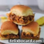 Three sloppy joe sliders stacked like a pyramid, ready to be served.