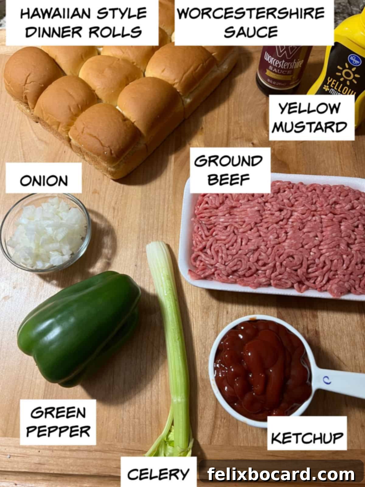 A flat lay of fresh ingredients for sloppy joe sliders including dinner rolls, Worcestershire sauce, yellow mustard, ground beef, chopped onion, green pepper, celery, and a bottle of ketchup.