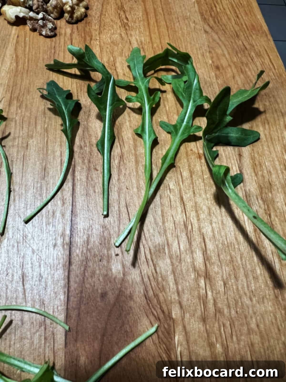 Arugula pieces with unusually long stems, showing the need for optional trimming.