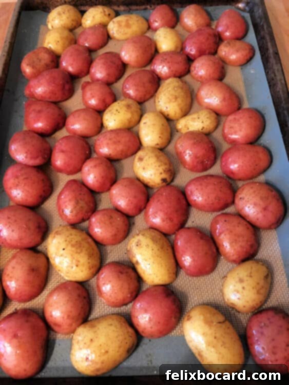 Potatoes arranged cut side down on a baking sheet before roasting