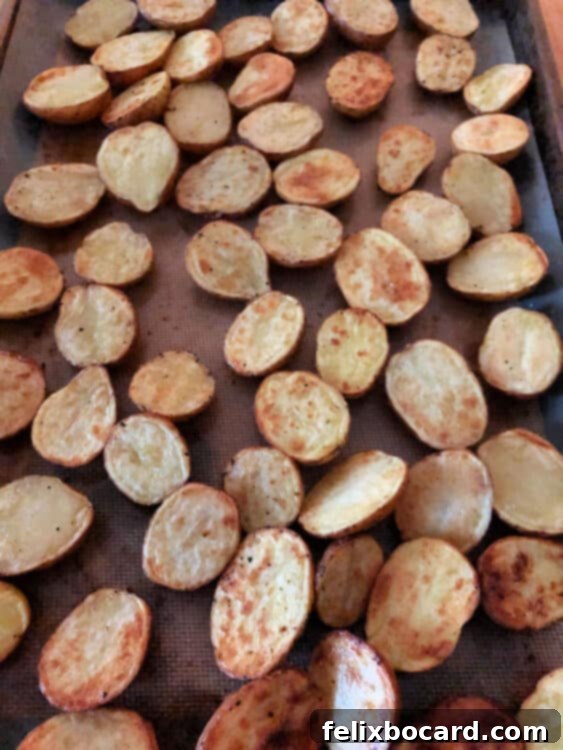 Partially cooked potatoes on a baking sheet after 20 minutes
